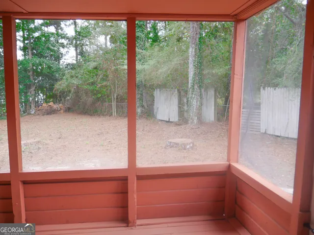 a view of a glass door and a yard