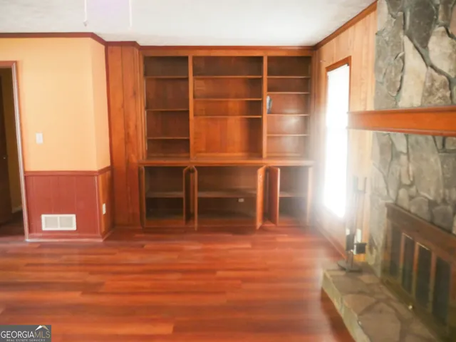 a view of a room with wooden floor and windows