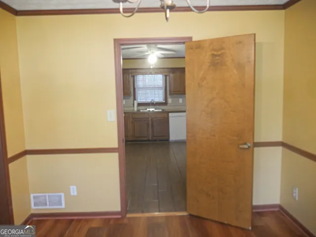an empty room with wooden floor and a window