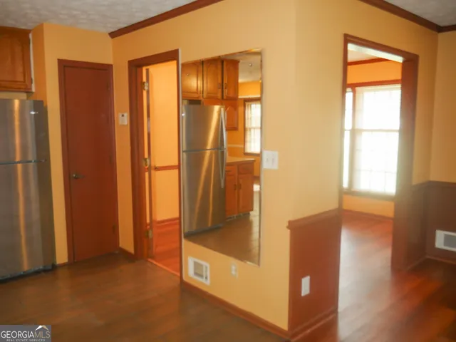 a view of a small space with wooden floor