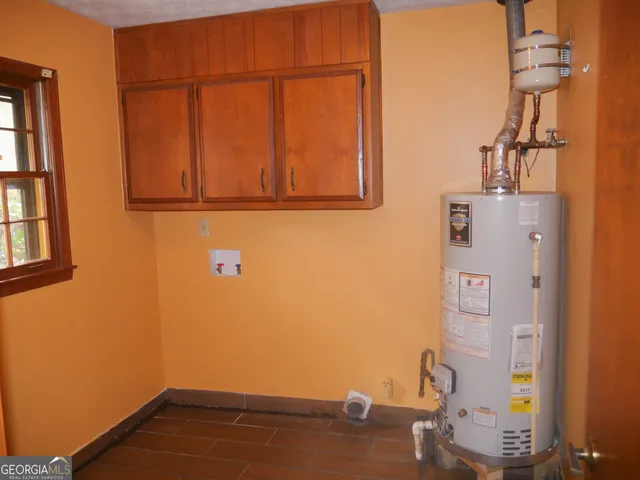 a view of kitchen with stainless steel appliances wooden floor