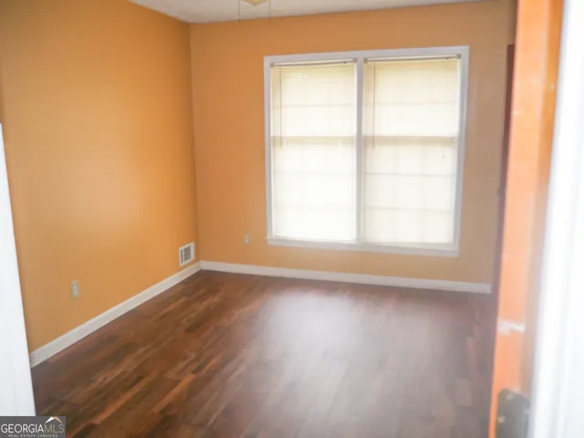 a view of a small space with wooden floor