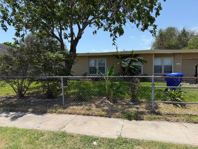 4617 Kasper Street Corpus Christi, TX 78415 - Photo 1 of 12 a front view of a house with garden