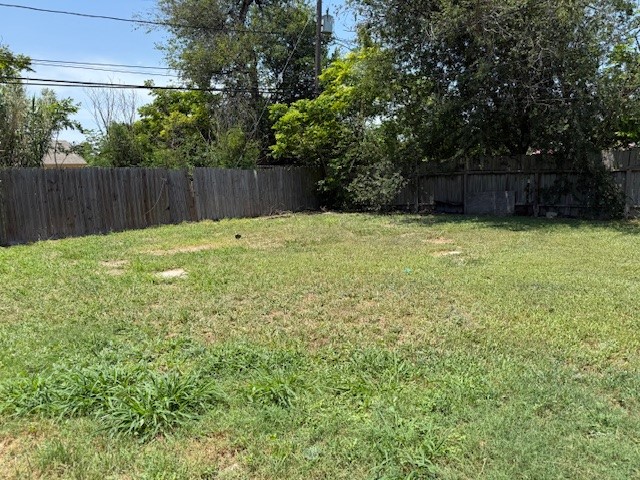 4617 Kasper Street Corpus Christi, TX 78415 - Photo 11 of 12 a view of a backyard with large trees and wooden fence