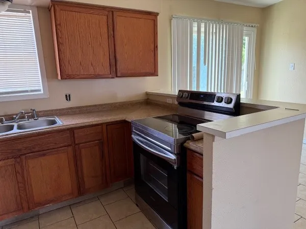 a kitchen with granite countertop cabinets stainless steel appliances and a sink