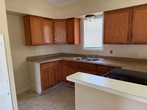 a kitchen with a sink dishwasher a stove and a microwave oven