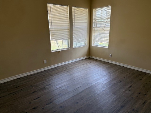 4617 Kasper Street Corpus Christi, TX 78415 - Photo 6 of 12 an empty room with wooden floor and windows