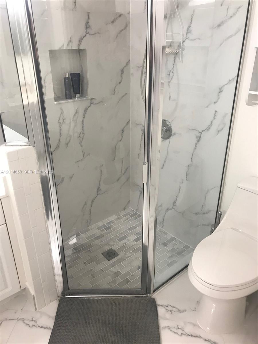 16654 Southwest 103rd Lane Miami, FL 33196 - Photo 17 of 20 a white toilet sitting next to a bath tub