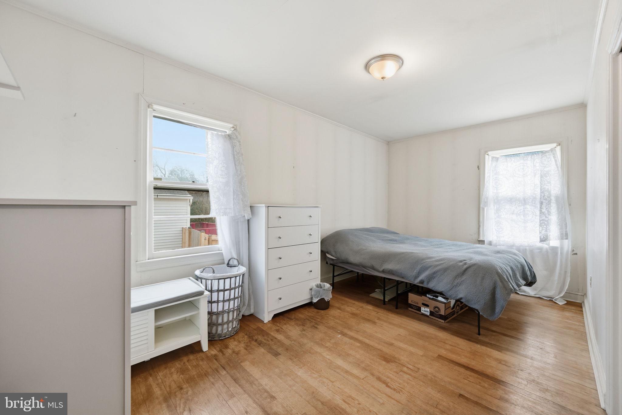 703 Northwest Drive Silver Spring, MD 20901 - Photo 12 of 25 a bedroom with a bed and a window