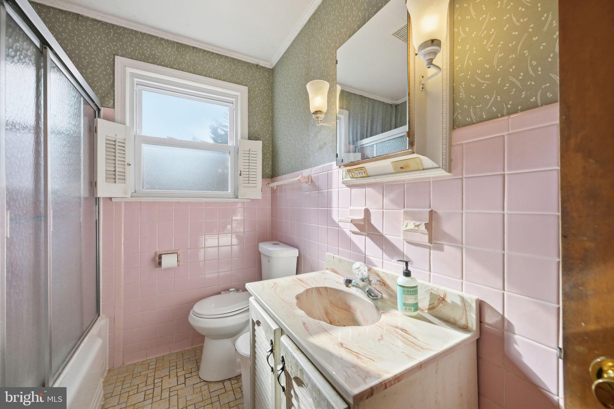 703 Northwest Drive Silver Spring, MD 20901 - Photo 14 of 25 a bathroom with a sink a toilet and mirror