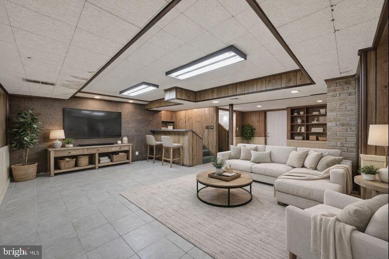 703 Northwest Drive Silver Spring, MD 20901 - Photo 17 of 25 a living room with furniture and a flat screen tv