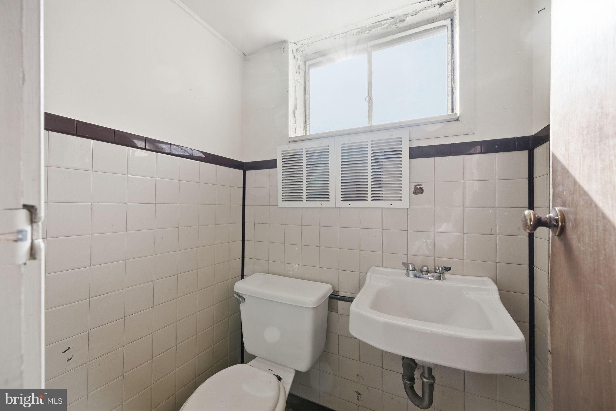 703 Northwest Drive Silver Spring, MD 20901 - Photo 21 of 25 a bathroom with a sink toilet and shower