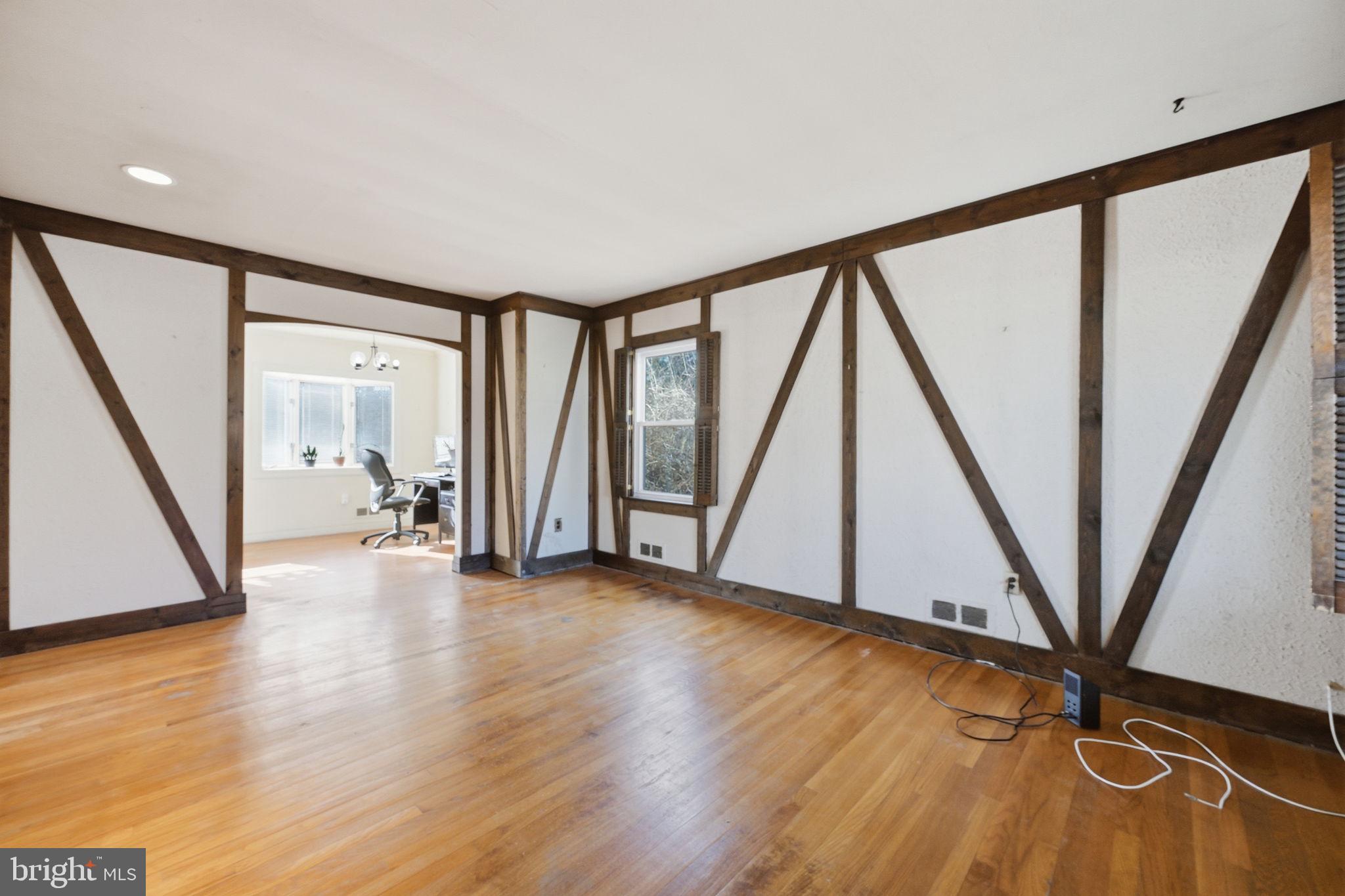 703 Northwest Drive Silver Spring, MD 20901 - Photo 4 of 25 a view of an empty room with wooden floor and stairs