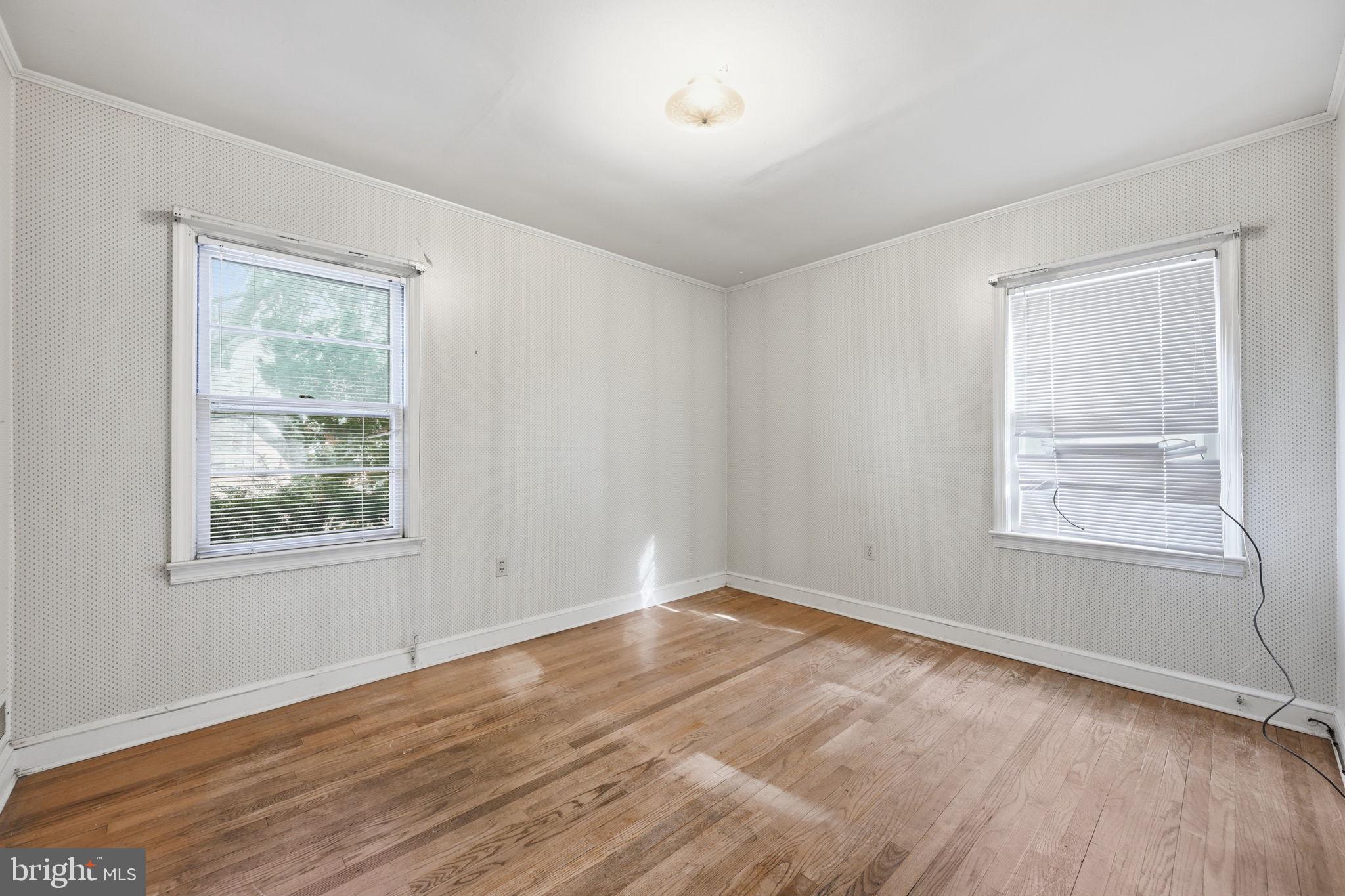 703 Northwest Drive Silver Spring, MD 20901 - Photo 9 of 25 an empty room with wooden floor and windows