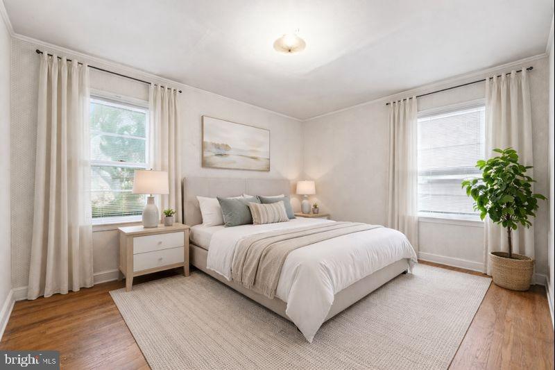 703 Northwest Drive Silver Spring, MD 20901 - Photo 10 of 25 a bedroom with a large bed and a potted plant