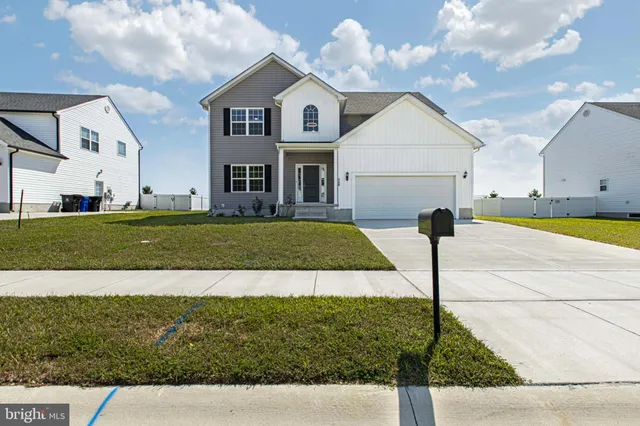 a view of staircase with white walls and railing