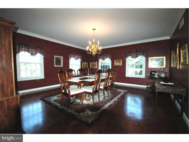 2652 North Sugan Road New Hope, PA 18938 - Photo 5 of 12 a dining room with wooden floor a chandelier a wooden table and chairs
