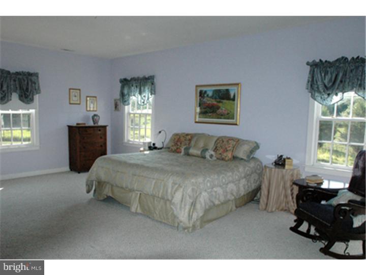 2652 North Sugan Road New Hope, PA 18938 - Photo 9 of 12 a bedroom with a bed and wooden floor