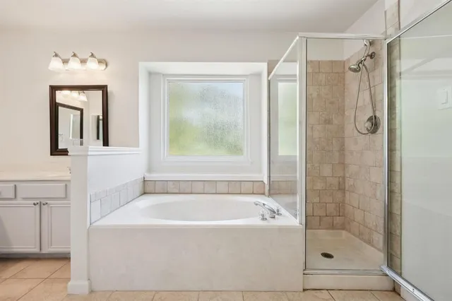 a bathroom with a sink vanity and mirror