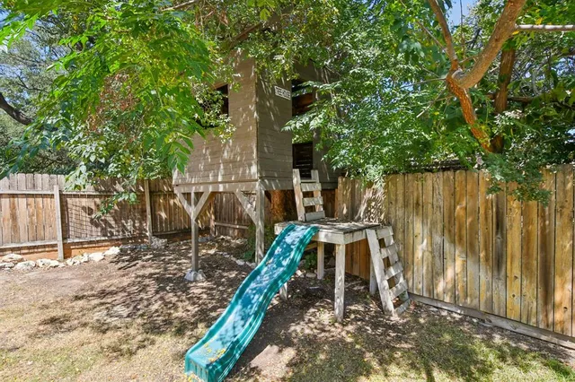 a view of a backyard with swimming pool