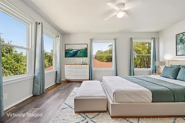 a bedroom with a large bed and a window