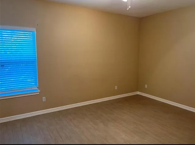 an empty room with wooden floor
