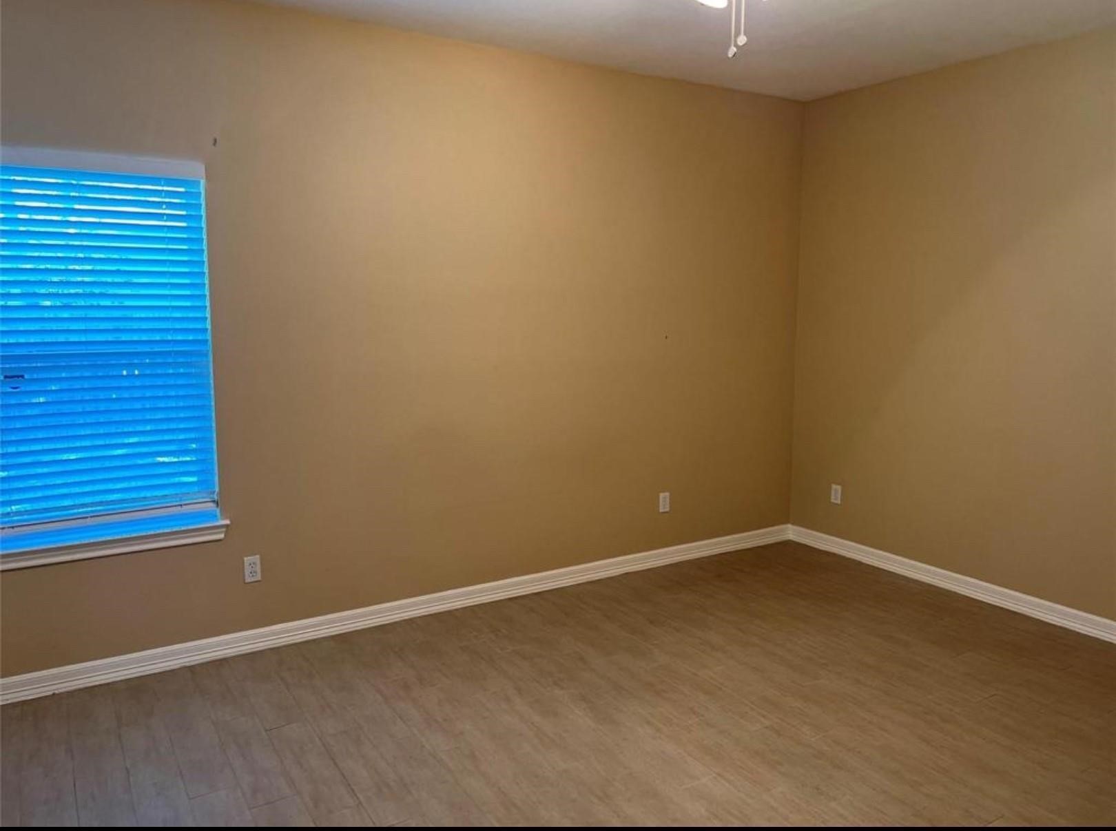 4733 16th Street Bacliff, TX 77518 - Photo 9 of 11 an empty room with wooden floor