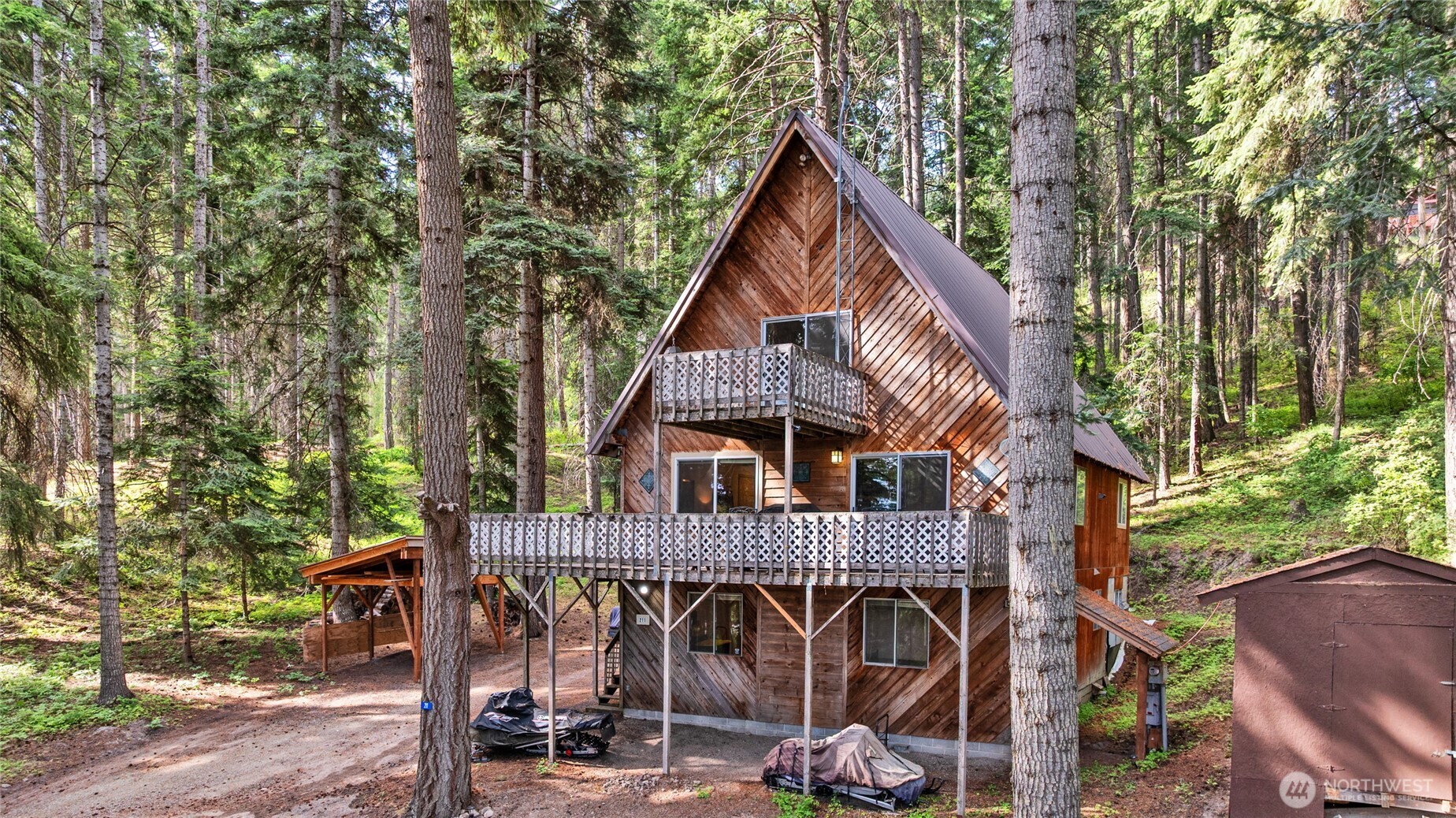 a view of a house with large windows and a small yard