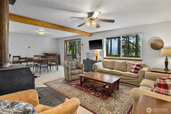 a living room with furniture ceiling fan and a rug