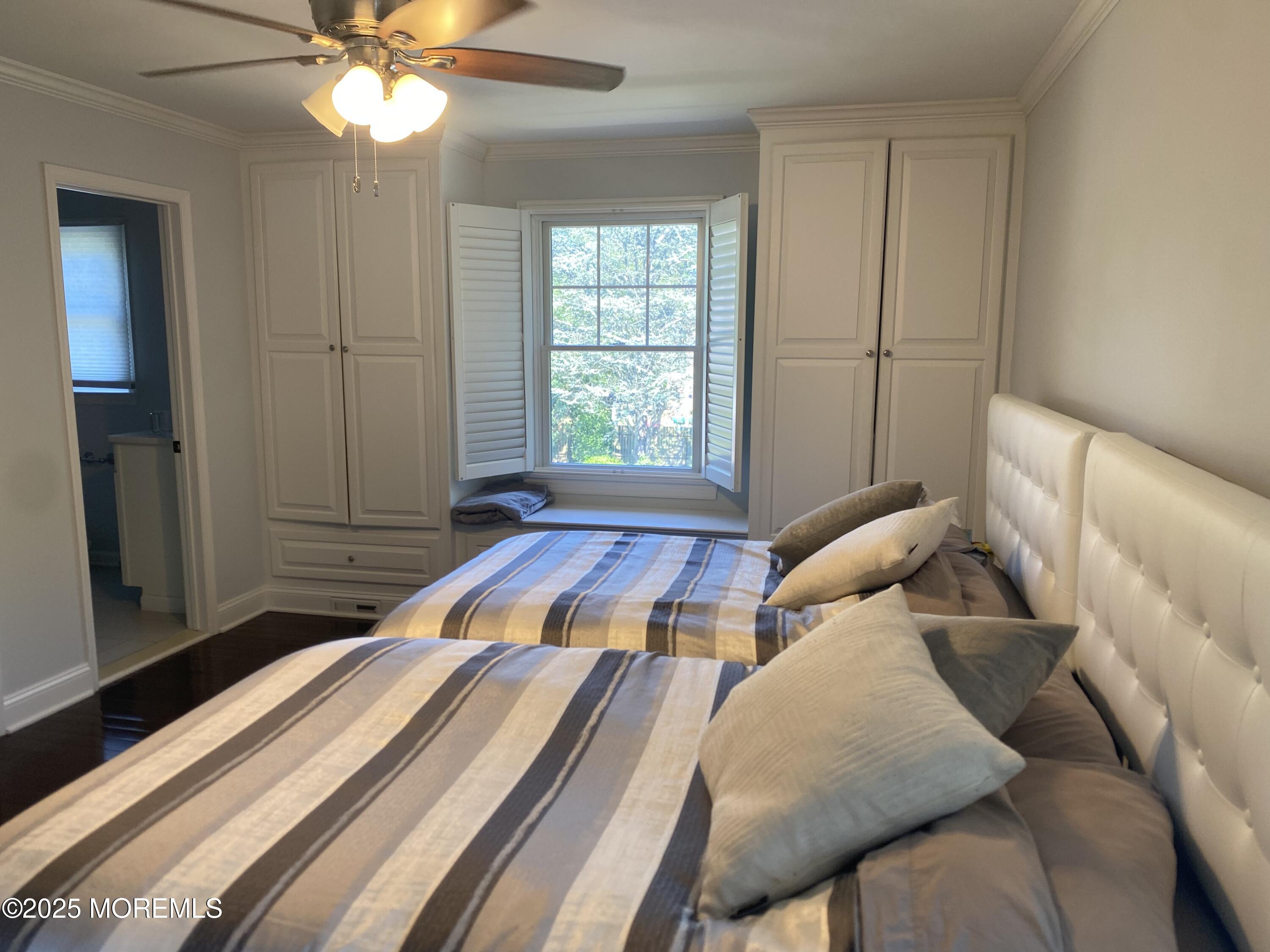 84 Forest Street West Long Branch, NJ 07764 - Photo 11 of 19 a bedroom with a bed and a chandelier