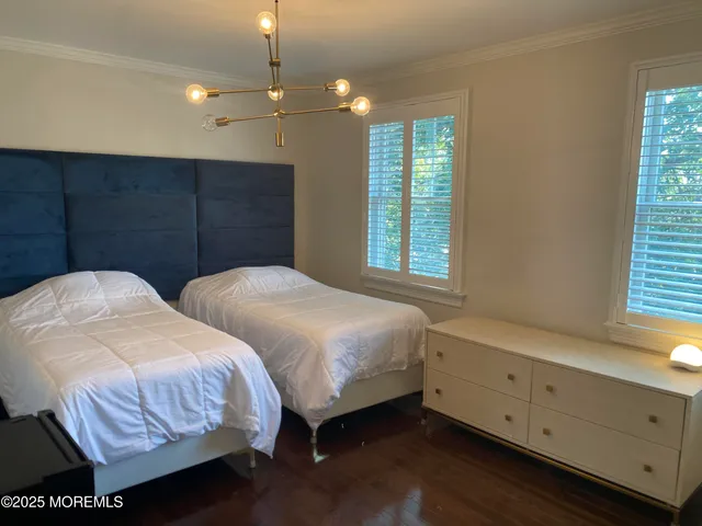 a bedroom with two beds and painted walls