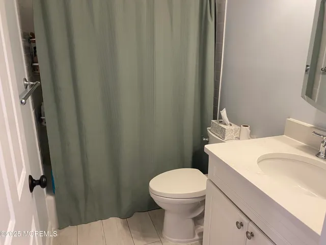 a white toilet sitting next to a bathroom sink