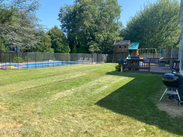 a view of a swimming pool with chairs in patio
