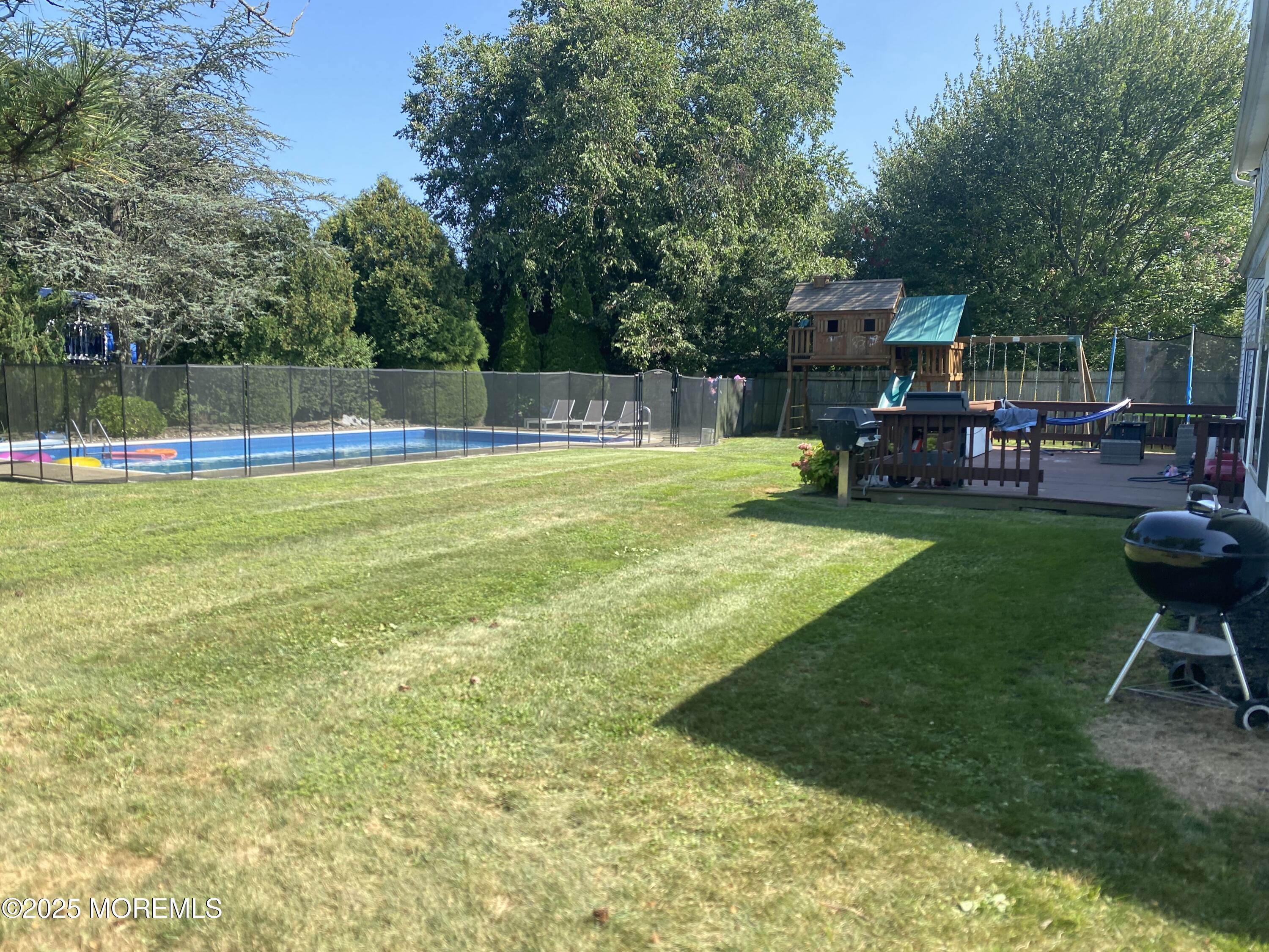 84 Forest Street West Long Branch, NJ 07764 - Photo 18 of 19 a view of a swimming pool with chairs in patio