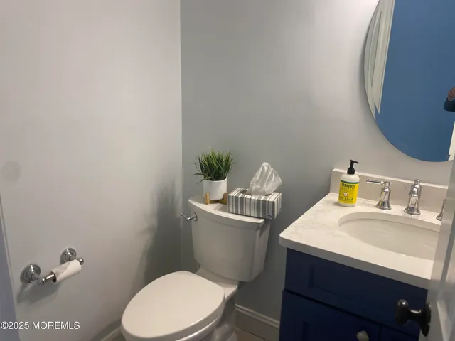 a bathroom with a sink a toilet and a mirror