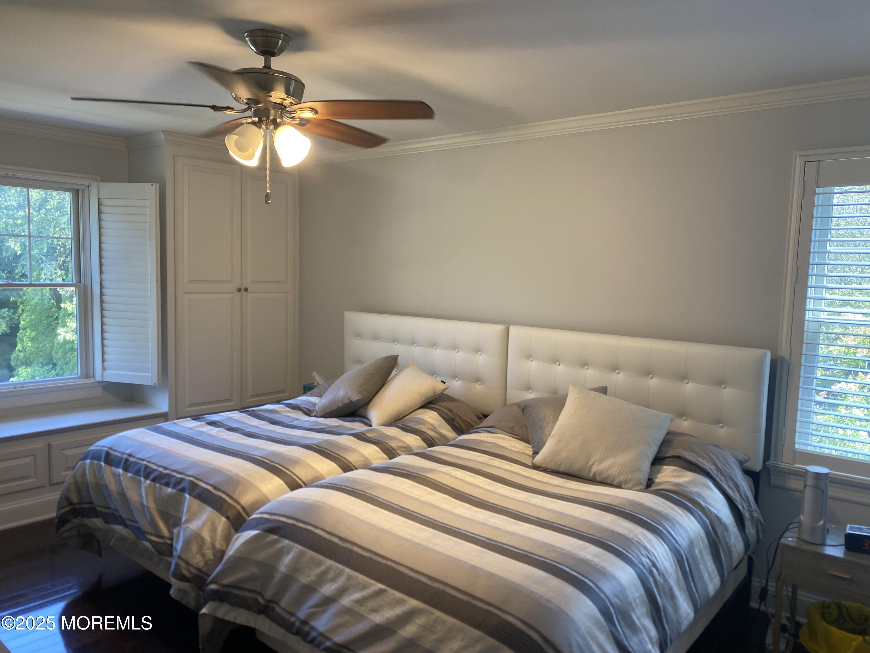 84 Forest Street West Long Branch, NJ 07764 - Photo 10 of 19 a bedroom with a bed and a chandelier