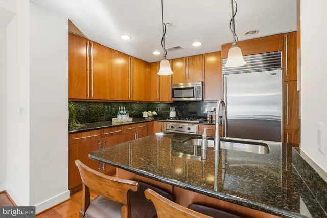 a kitchen with counter top space and wooden floor