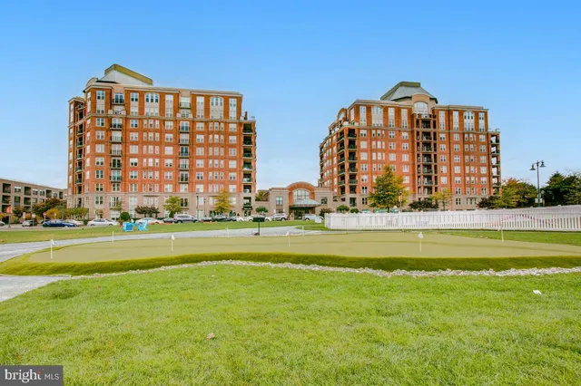 a view of a large building with a big yard and large trees