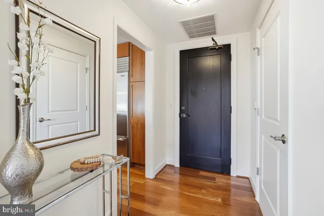a kitchen with stainless steel appliances granite countertop a sink a stove and a wooden cabinets