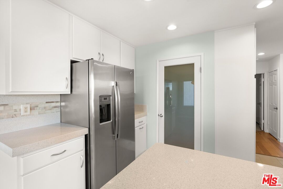 4643 East 4th Street, Unit 22 Long Beach, CA 90814 - Photo 17 of 40 a kitchen with a refrigerator and a sink