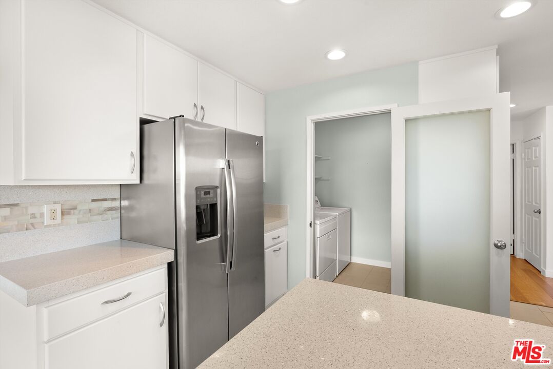 4643 East 4th Street, Unit 22 Long Beach, CA 90814 - Photo 18 of 40 a kitchen with a refrigerator and a sink