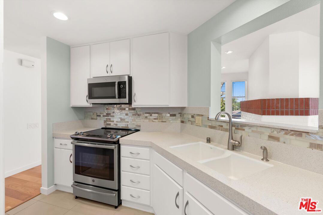 4643 East 4th Street, Unit 22 Long Beach, CA 90814 - Photo 20 of 40 a kitchen with a sink stove and microwave