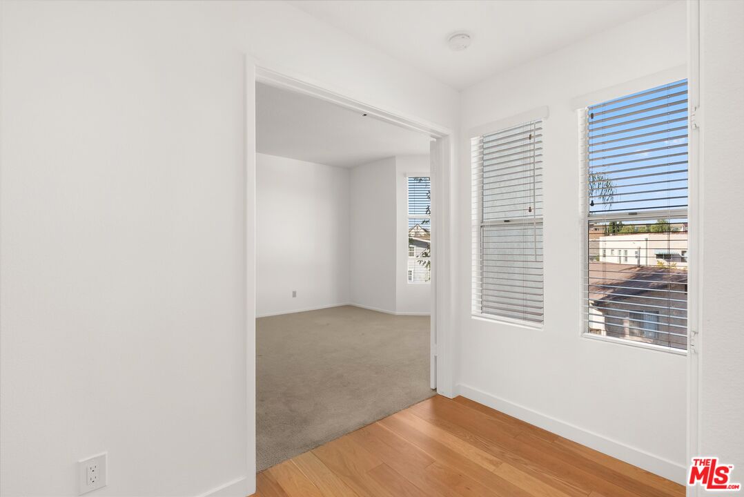 4643 East 4th Street, Unit 22 Long Beach, CA 90814 - Photo 26 of 40 a view of an empty room with wooden floor and a window