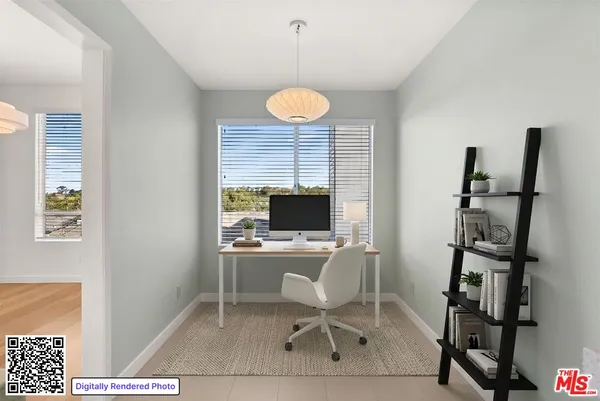 a view of an empty room with wooden floor fireplace and a window