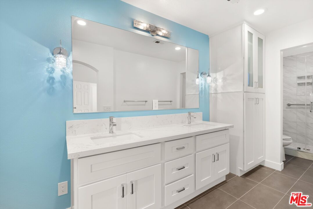 4643 East 4th Street, Unit 22 Long Beach, CA 90814 - Photo 31 of 40 a bathroom with a sink double vanity and a mirror