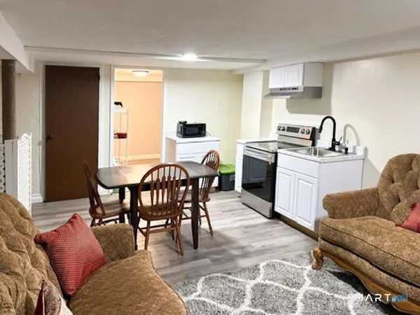 a living room with furniture a dining table and chairs