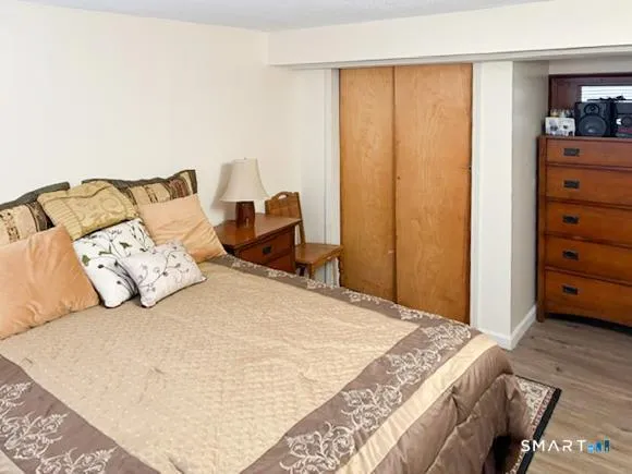 a bed sitting in a bedroom next to a cabinet