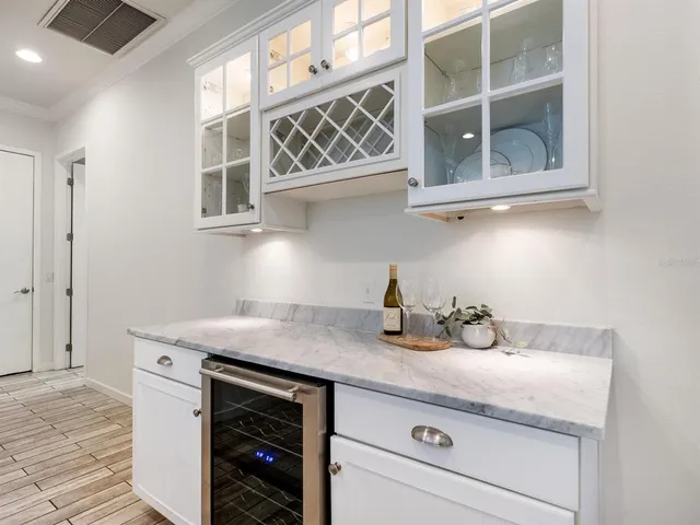 a kitchen with a sink stove and white cabinets