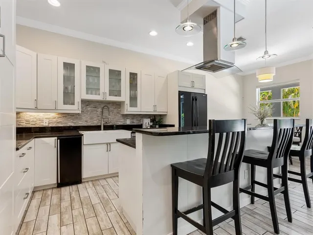 a kitchen with granite countertop white cabinets and white appliances