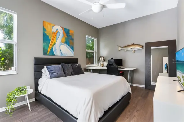 a workspace with chandelier fan and windows